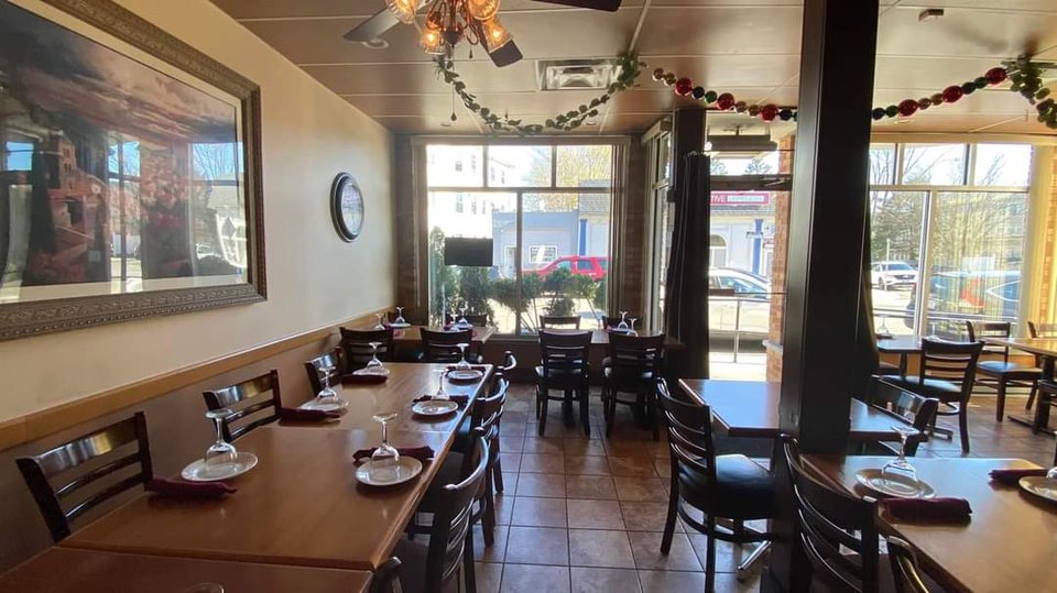 Cozy Italian restaurant interior with casual seating.